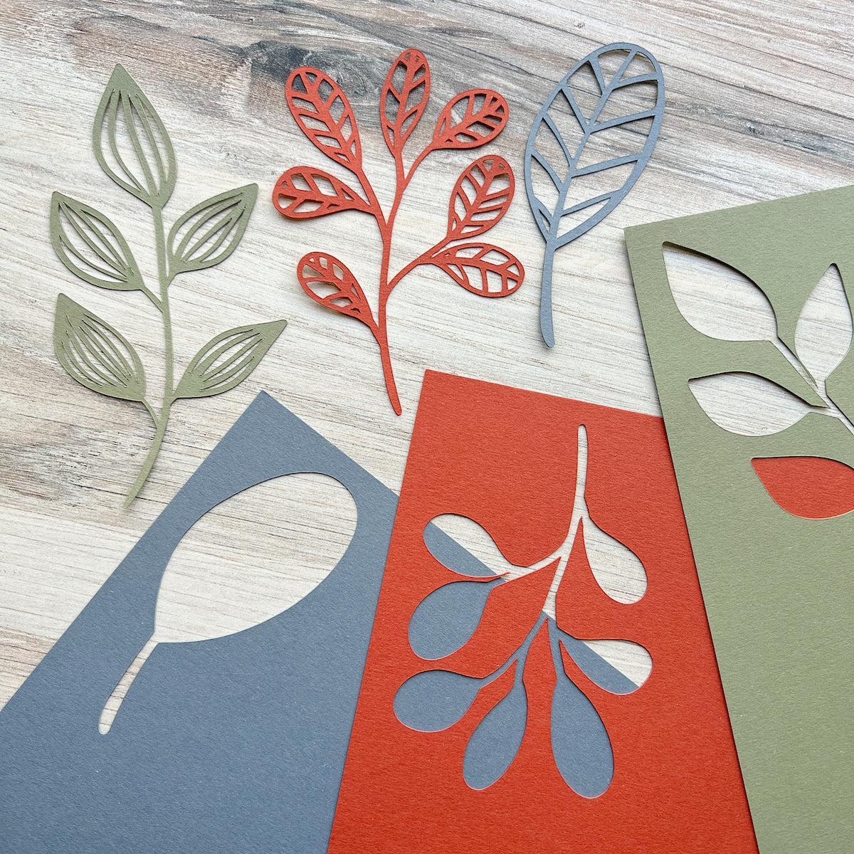 Materica paper leaves alongside their original cardstock sheets